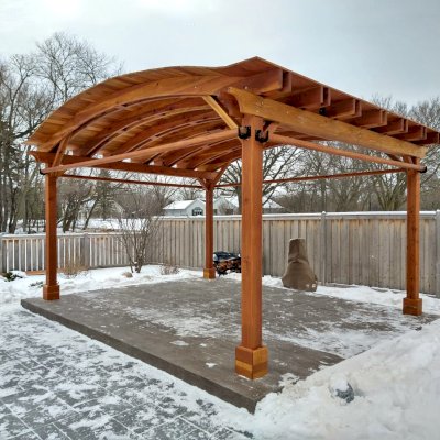 Backyard Pavilion Kits (Options: 15' L x 18' Arc W, California Redwood, 2 Post Electrical Wiring Trims, 4-Post Anchor Kit for Concrete, 1 Ceiling Fan Base, No Privacy Panels, 4 Curtain Rods, 9 ft Post Height, Transparent Premium Sealant). Photo Courtesy of M. McDonald of Lake Barrington, Illinois.